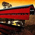 Sunrise reflections over covered bridge